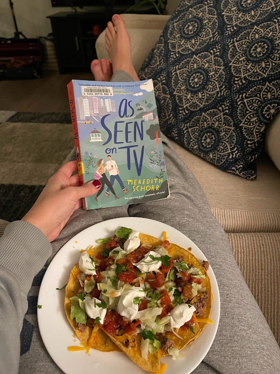 Jen with plate of tacos and book